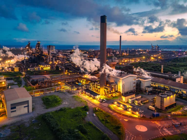 Aerial view of the port talbot steelworks emitting smoke and steam at dusk, located in south wales
